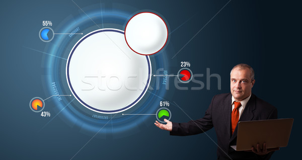 businessman in suit holding a laptop and presenting abstract modern pie chart Stock photo © ra2studio