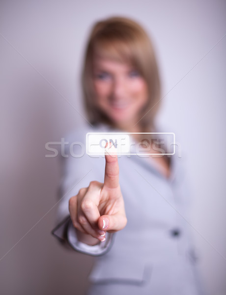 woman pressing ON / OFF button Stock photo © ra2studio
