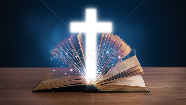 Open holy bible with glowing cross in the middle Stock photo © ra2studio