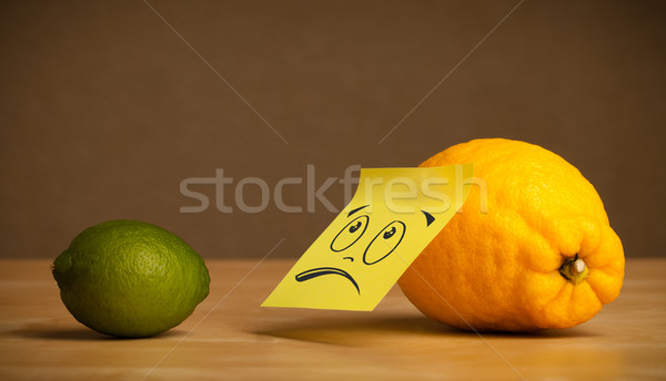 Lemon with sticky post-it note looking sadly at lime Stock photo © ra2studio