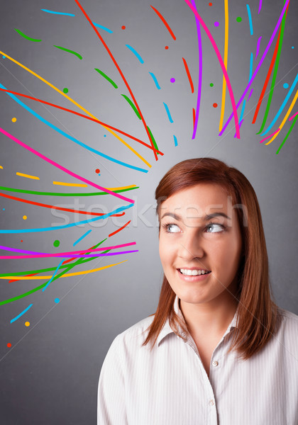 Young girl thinking with colorful abstract lines overhead Stock photo © ra2studio