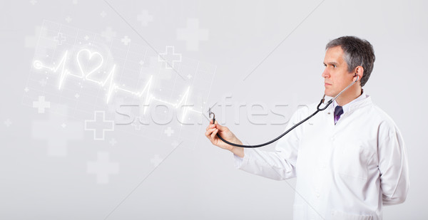 Stock photo: Doctor examinates heartbeat with abstract heart