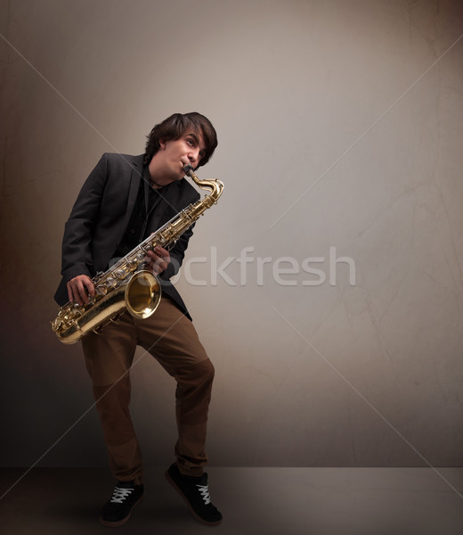 Young musician playing on saxophone Stock photo © ra2studio