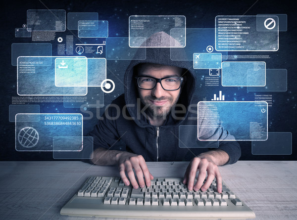 Nerd with glasses hacking websites Stock photo © ra2studio