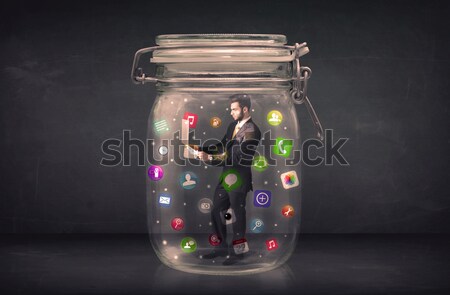 Businesswoman captured in a glass jar with colourful app icons c Stock photo © ra2studio