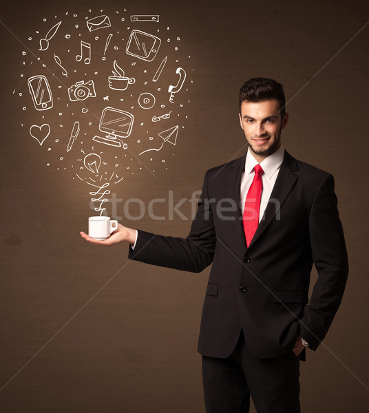 Businessman holding a white cup with social media icons Stock photo © ra2studio