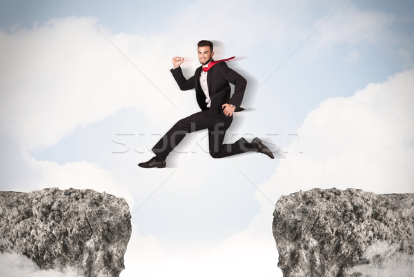 смешные деловой человек прыжки пород разрыв бизнеса Сток-фото © ra2studio