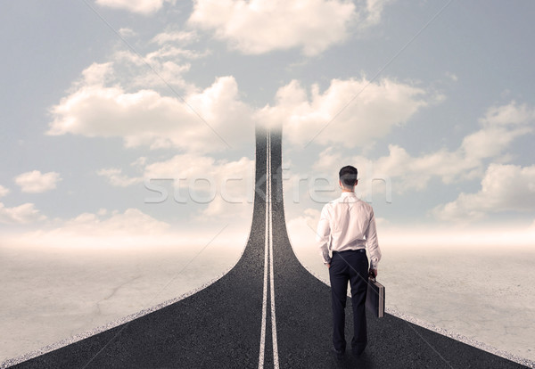 Businessman looking at 3d road that goes up in the sky Stock photo © ra2studio