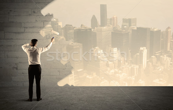 Salesman painting city scape on wall Stock photo © ra2studio