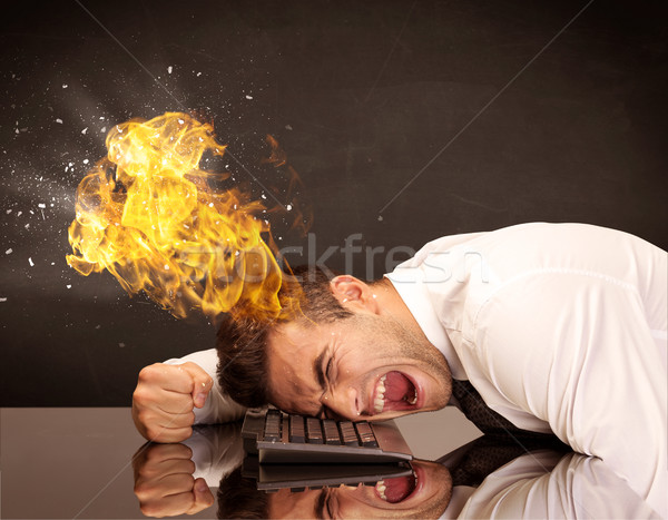 Stressed business man's head is burning Stock photo © ra2studio