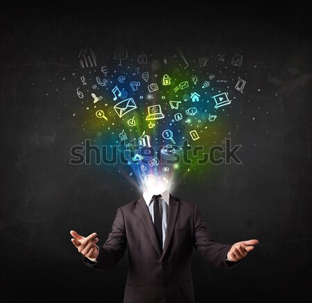 Stock photo: Business man with glowing media icons exploding head 