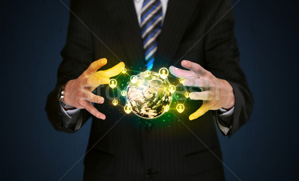 Businessman holding a social media globe Stock photo © ra2studio