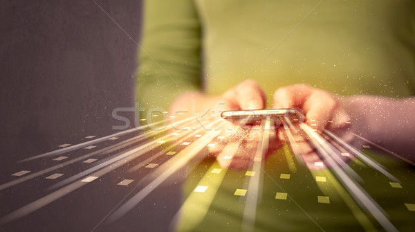 Person holding smarthphone with technology light applications Stock photo © ra2studio