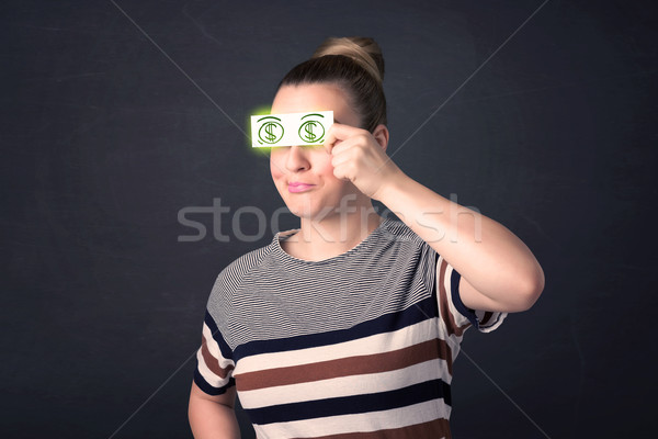 Young girl holding paper with green dollar sign Stock photo © ra2studio