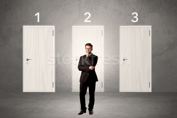 Businessman thinking in front of three doors  Stock photo © ra2studio