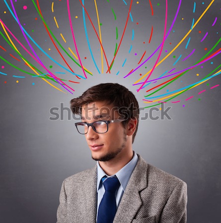 Young man thinking wiht colorful abstract lines overhead Stock photo © ra2studio