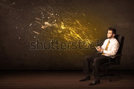 Worker with airbrush painting with glowing golden paint  Stock photo © ra2studio