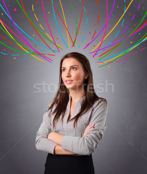 Young girl thinking with colorful abstract lines overhead Stock photo © ra2studio