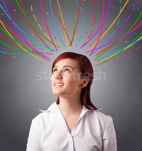 Young girl thinking with colorful abstract lines overhead Stock photo © ra2studio