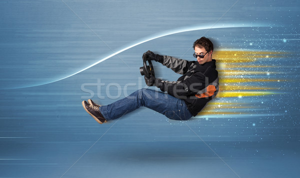 Jonge man rijden denkbeeldig snel auto wazig Stockfoto © ra2studio