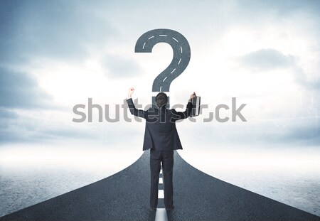 Businessman on rock mountain with a question mark Stock photo © ra2studio