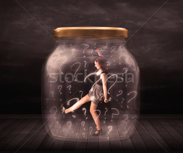 Businesswoman locked into a jar with question marks concept Stock photo © ra2studio