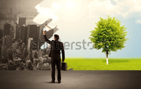 Salesman painting tree instead of city Stock photo © ra2studio