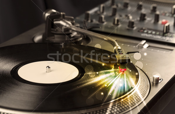 Music player playing vinyl with glow lines comming from the need Stock photo © ra2studio