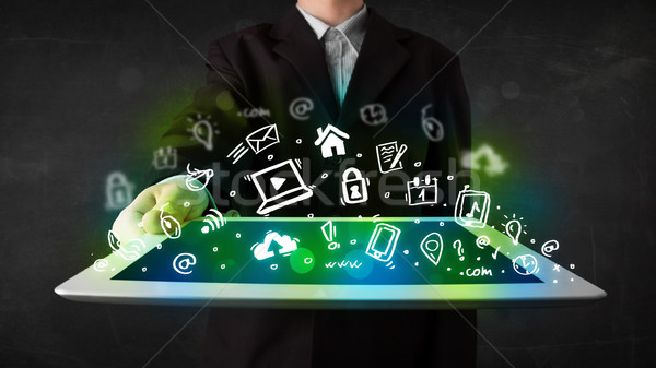 Person holding tablet with green media icons and symbols Stock photo © ra2studio