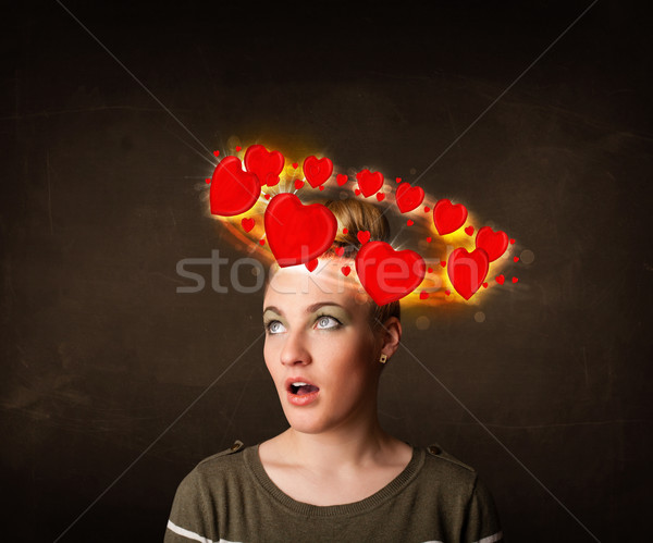 teenager girl with heart illustrations circleing around her head Stock photo © ra2studio