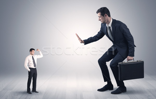 Giant businessman scared of small businessman Stock photo © ra2studio