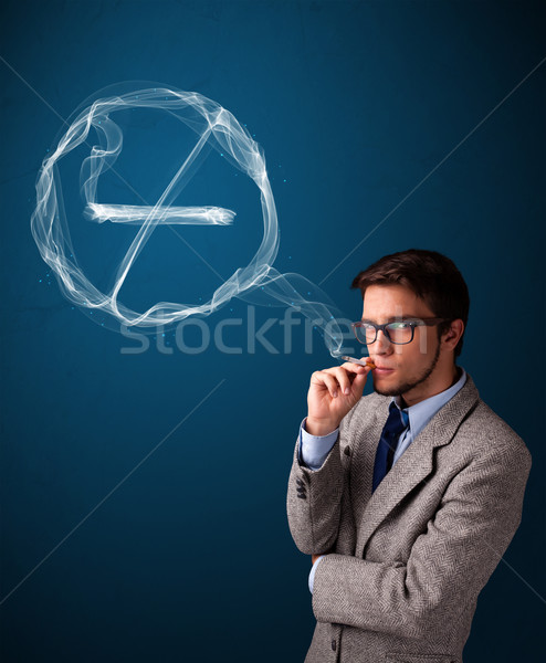Stock photo: Young man smoking unhealthy cigarette with no smoking sign