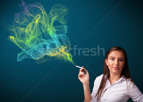 Pretty lady smoking cigarette with colorful smoke Stock photo © ra2studio