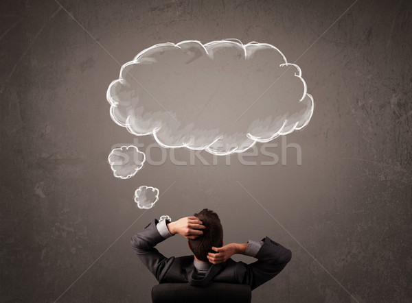 Businessman sitting with cloud thought above his head Stock photo © ra2studio