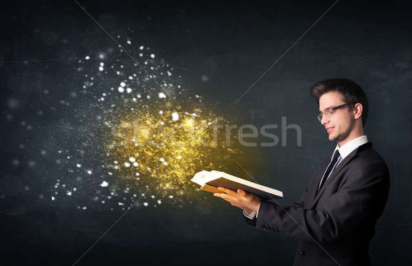 Young guy reading a magical book Stock photo © ra2studio