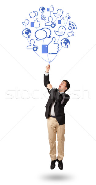 Stock photo: Attractive man holding social icon balloon