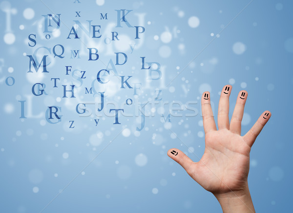 Happy smiley fingers looking at mixture of bokeh letters Stock photo © ra2studio