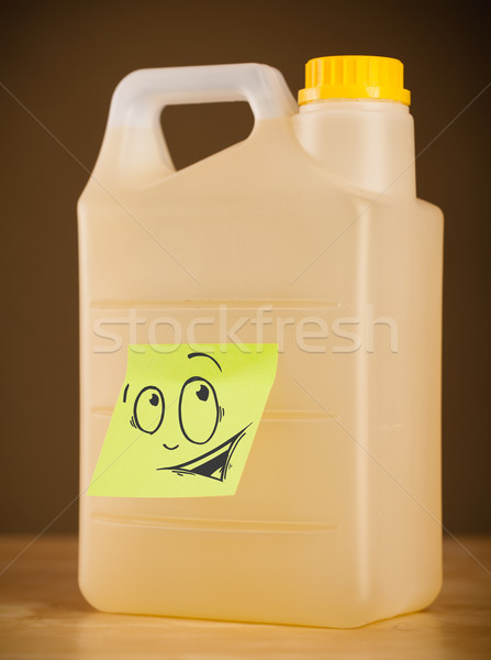 Stock photo: Post-it note with smiley face sticked on can