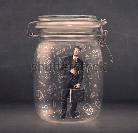 Business man captured in glass jar with hand drawn media icons c Stock photo © ra2studio