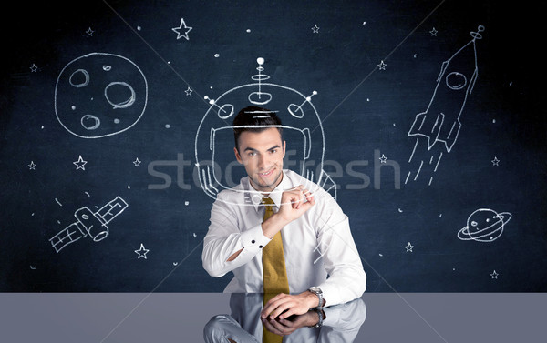 Sales person drawing helmet and space rocket Stock photo © ra2studio