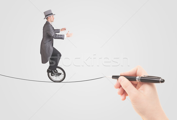 Businessman riding monocycle on a rope drawn by hand Stock photo © ra2studio