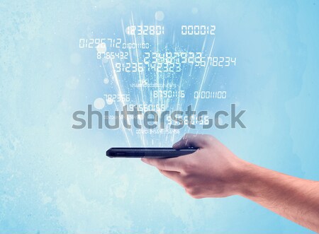 Hand holding phone with digital numbers Stock photo © ra2studio