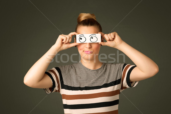 Stock photo: Young silly girl looking with hand drawn eye balls on paper