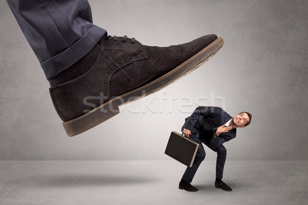Small man trampled by the great power Stock photo © ra2studio
