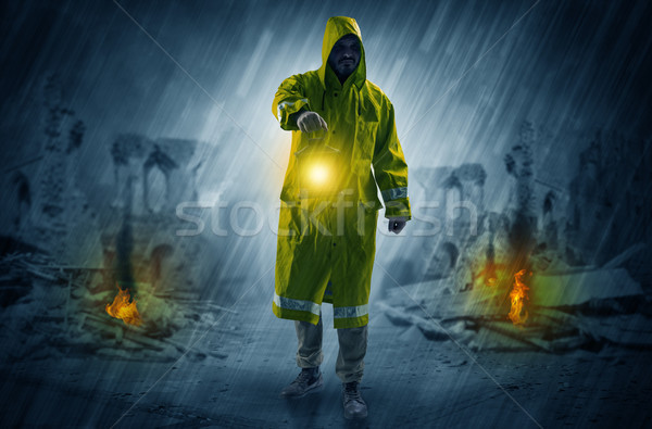 Man with a glowing lantern at a catastrophe scene Stock photo © ra2studio