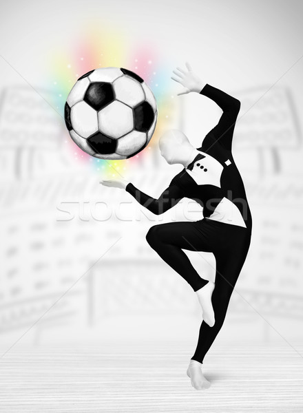 man in full body suit holdig soccer ball Stock photo © ra2studio