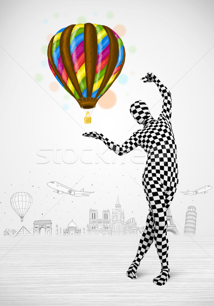 Stock photo:  man in full body suit holding balloon