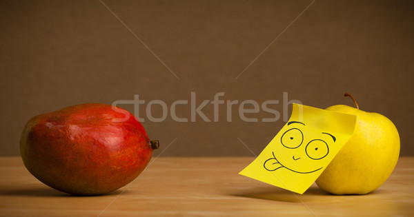 Apple with post-it note sticking out tongue to mango Stock photo © ra2studio