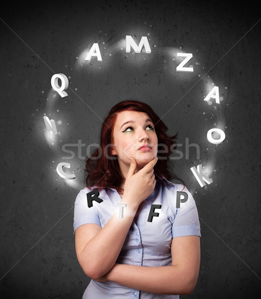 Young woman thinking with letter circulation around her head Stock photo © ra2studio