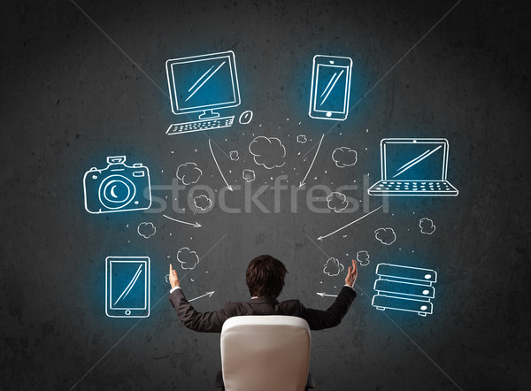 бизнесмен сидят мультимедийные иконки молодые Сток-фото © ra2studio